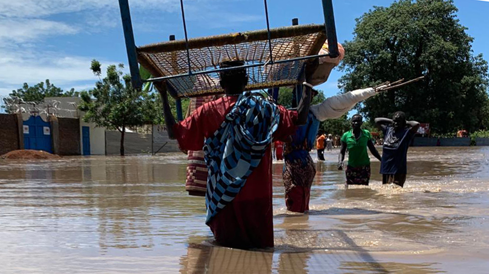 People navigate flood waters in South Sudan